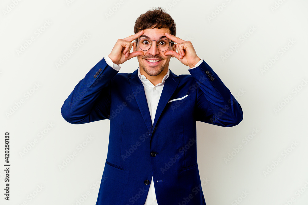 Young business caucasian man isolated on white background keeping eyes opened to find a success opportunity. Young business caucasian man isolated on white background keeping eyes opened to find a success opportunity.