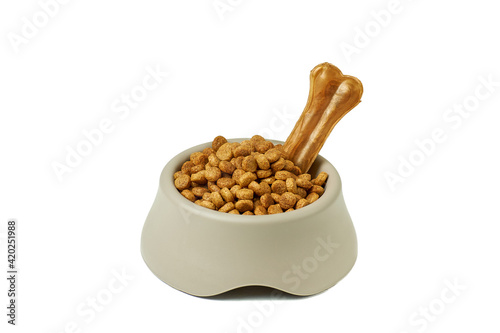 Dry dog food in bowl on white background