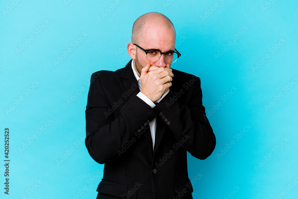 Young business caucasian bald man isolated on blue background covering mouth with hands looking worried. Young business caucasian bald man isolated on blue background covering mouth with hands looking worried.
