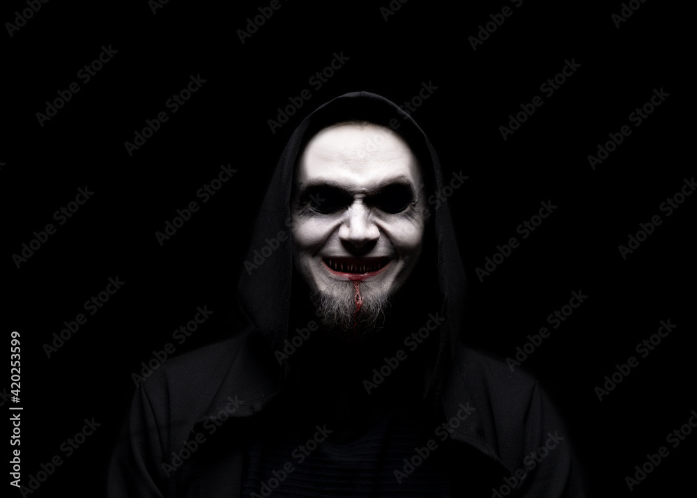 Horrible man with scary mouth and eyes. Demon laughing with big fangs full of blood. Dead characters at night evil dressing. Horrible man with scary mouth and eyes. Demon laughing with big fangs full of blood. Dead characters at night evil dressing.