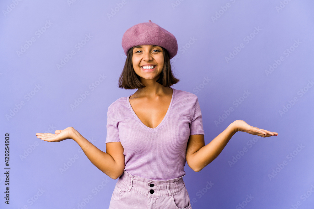 Young mixed race woman showing a welcome expression. Young mixed race woman showing a welcome expression.