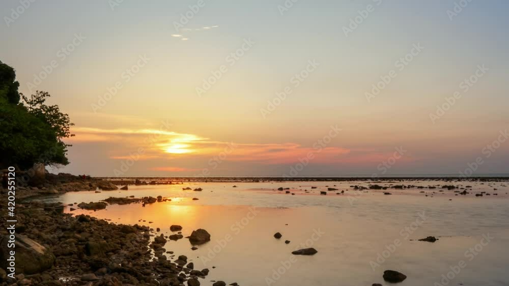4K. 4096x2304p. 24 FPS. Nature video Time lapse landscape view of sunset in sea. Rock beach and Island or mountain in sea. Golden sky sunset or sunrise 4K. 4096x2304p. 24 FPS. Nature video Time lapse landscape view of sunset in sea. Rock beach and Island or mountain in sea. Golden sky sunset or sunrise