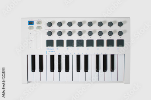 White midi keyboard with knobs and pads