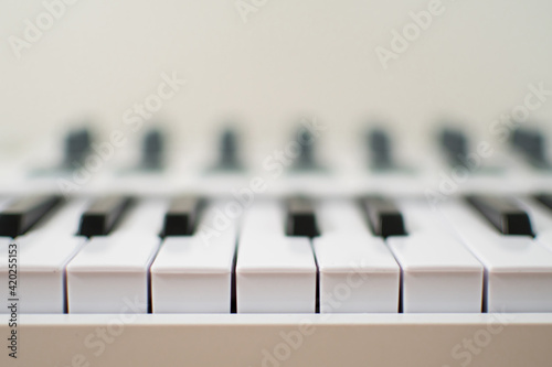 White midi keyboard with knobs and pads