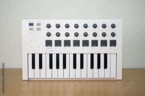 White midi keyboard with knobs and pads