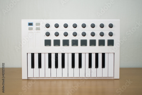 White midi keyboard with knobs and pads
