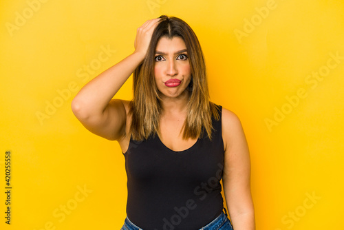 Young indian woman isolated on yellow background being shocked, she has remembered important meeting.
