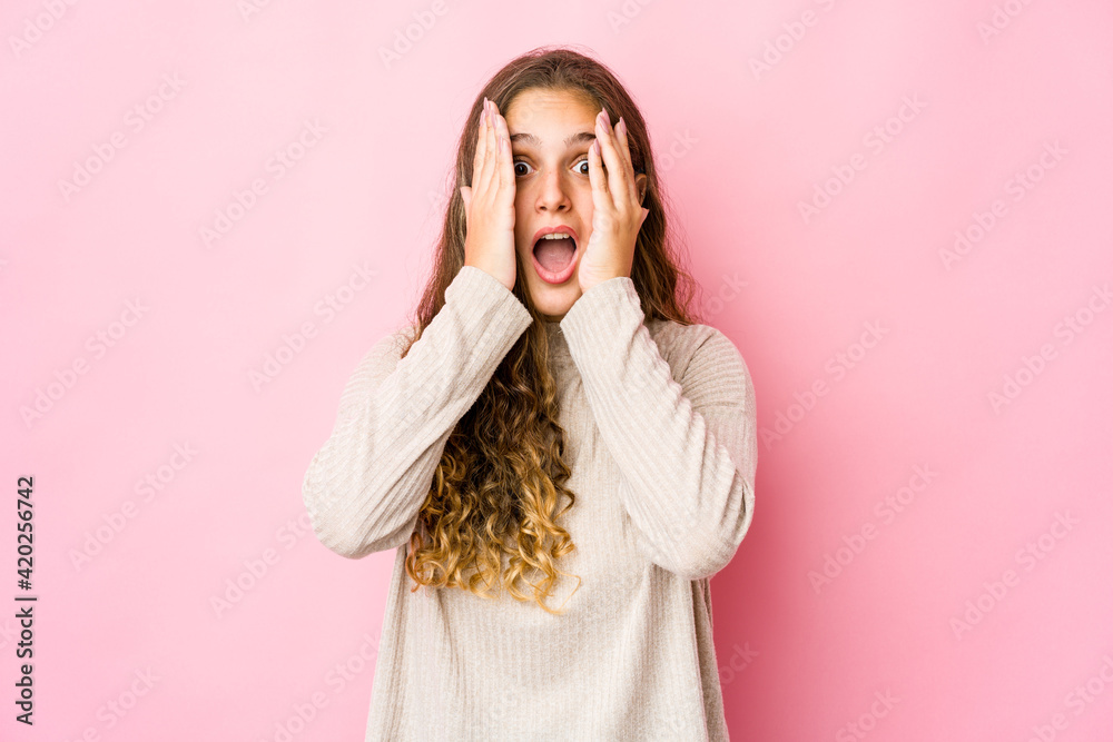 Young caucasian woman having fun covering half of face with palm.