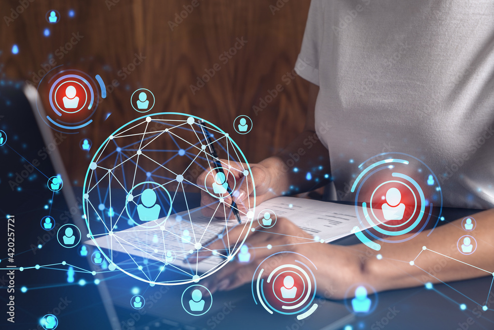 Fototapeta premium A potential employee signing the contract to boost her career and gain new opportunities in personal growth. Hiring a new talented crew. Social media hologram icons. Women in business concept.