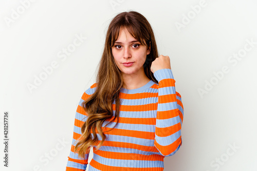 Young caucasian cute woman isolated on white background showing fist to camera, aggressive facial expression.