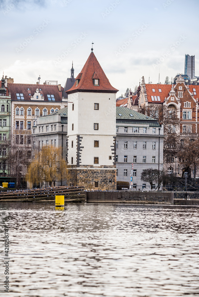 Fototapeta premium Prague, Czech republic - March 12, 2021. Historic building of Malostranska Water Tower (vodarna) by Moldau river