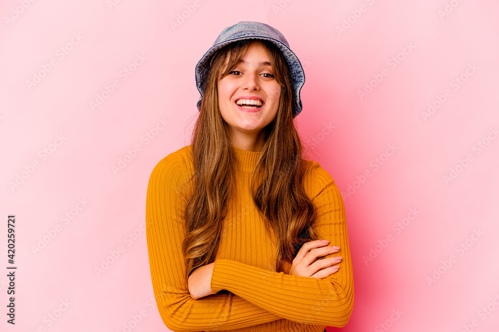 Young caucasian woman wearing fishermans hat isolated laughing and having fun. Young caucasian woman wearing fishermans hat isolated laughing and having fun.
