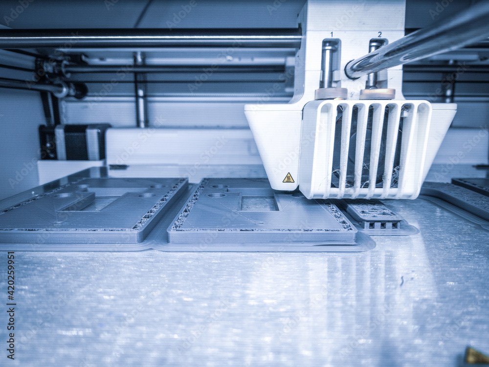 3D printer, printing with plastic wire filament in additive manufacturing technique.