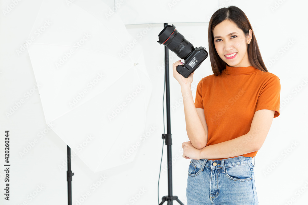 Portrait photographer woman at home holding a camera. Technology and lifestyle indoors. Happy optimistic cute young beautiful photographer woman camera indoors at home.