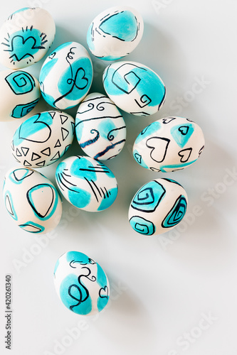 Creative trendy painted easter eggs on white background.
