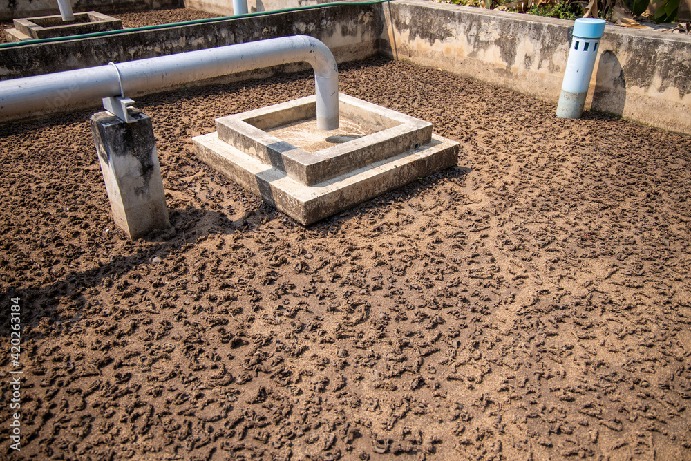 Sludge drying bed in wastewater treatment plant system, brown sand in