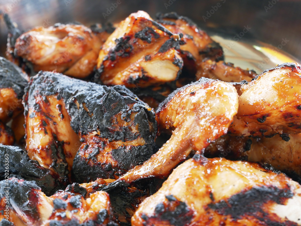 Pieces of chicken that have been grilled and ready to serve. Has been seasoned with special spices before being grilled.
