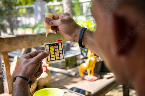 Man using chlorine and ph tester level meter for check quality of water from sewage in waste-water plant. 