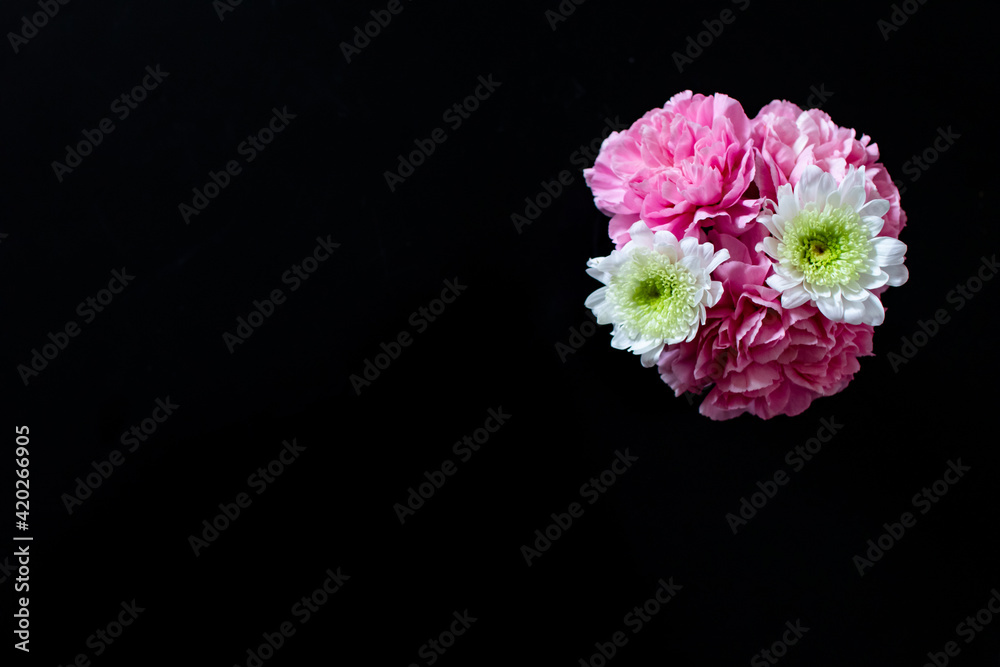 Bunch of flowers on black background. Space for advertising text and floral decoration, black background and top view. Bunch of flowers on black background. Space for advertising text and floral decoration, black background and top view.