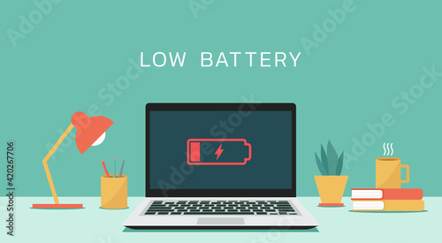 Laptop computer with low battery icon on screen, vector flat design illustration