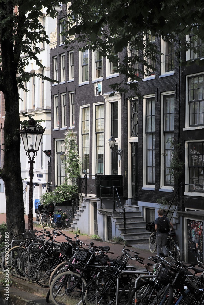 Amsterdam Street View with Canal Houses, Bicycles, and Traditional Lamppost