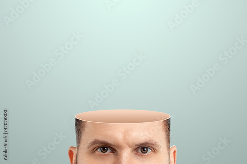 Close-up of a man's head cut off from the crown, no brain. Vacuum in the human head. Creative background.