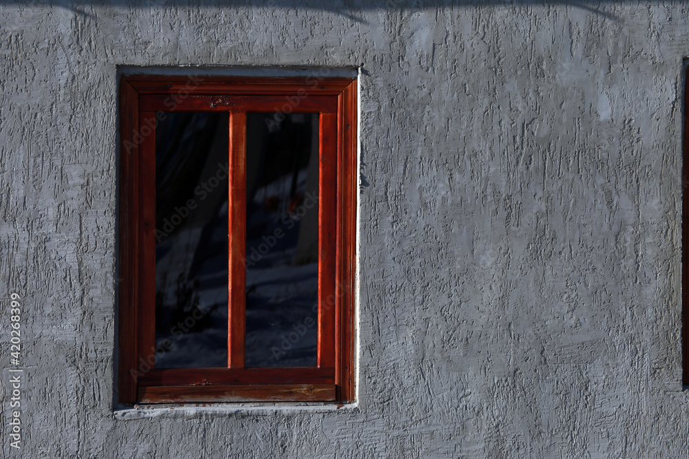 Wooden window on the wall of a house Wooden window on the wall of a house