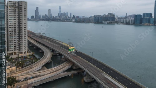 Night to day car traffic on Island Eastern Corridor which is an expressway built along the northeastern shore of Hong Kong Island