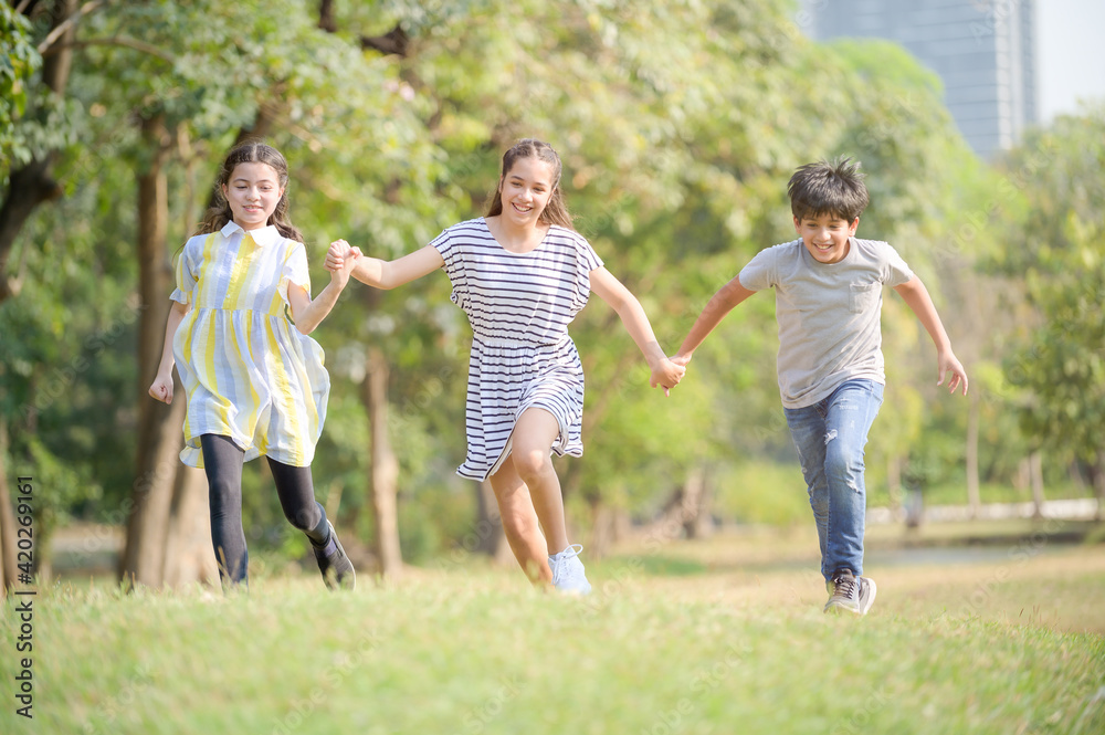 A half-Thai-Indian boy and a half-Thai-European girl friend races in a park while learning outside of school A half-Thai-Indian boy and a half-Thai-European girl friend races in a park while learning outside of school