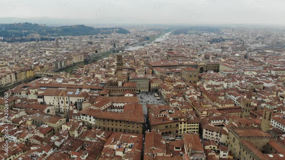 Signoria Square. L-shaped square in front of the Palazzo Vecchio in Florence. Italy from a bird's eye view. Panoramic view from a drone in Florence. People are walking around the square. Signoria Square. L-shaped square in front of the Palazzo Vecchio in Florence. Italy from a bird's eye view. Panoramic view from a drone in Florence. People are walking around the square.