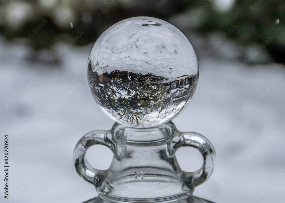 snowy garden scene reflected upside down in a crystal ball snowy garden scene reflected upside down in a crystal ball