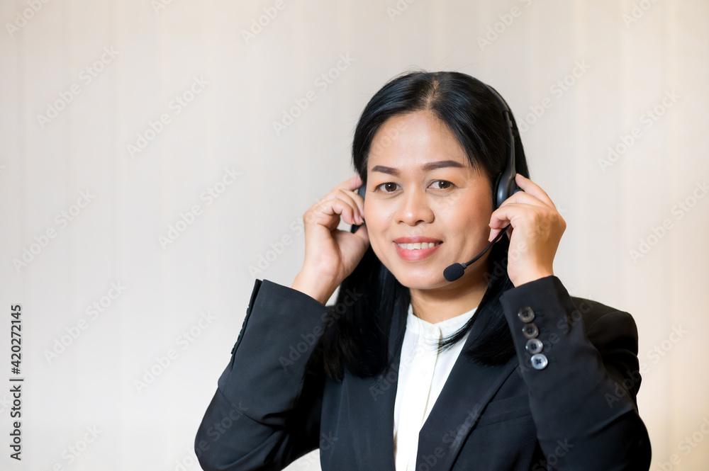 Portrait of asian businesswoman smiling and hearing headphone Portrait of asian businesswoman smiling and hearing headphone