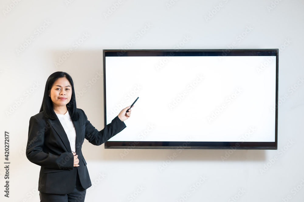 Female office worker presenting through blank television screen Female office worker presenting through blank television screen