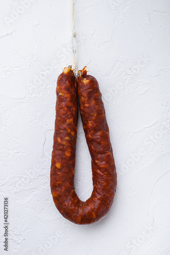 Dry cured chorizo sausage on white background, topview