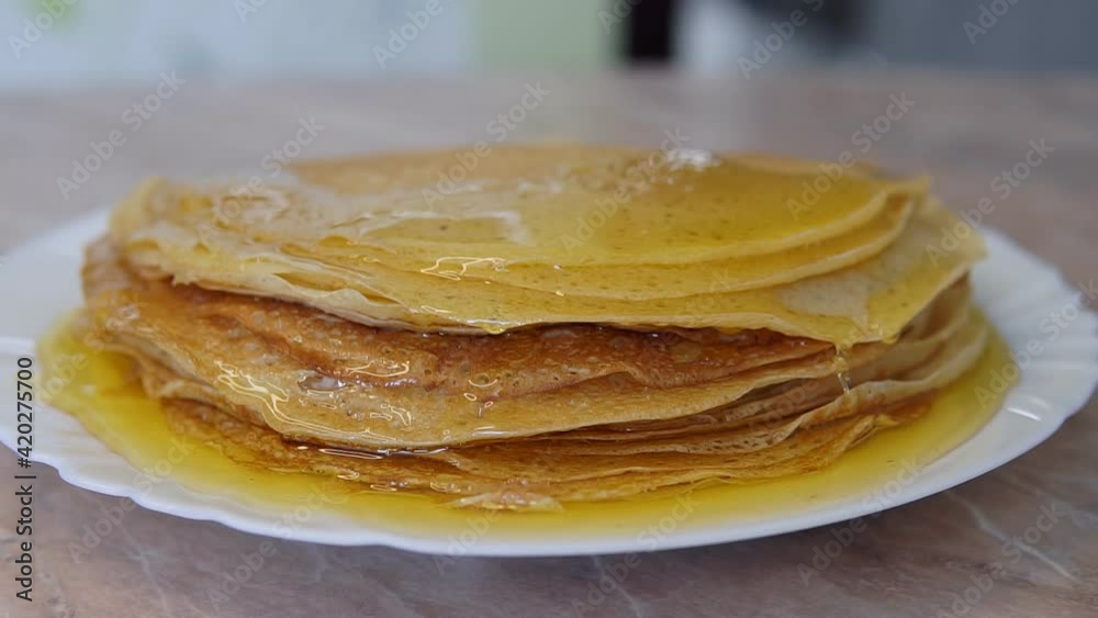 pancakes on a plate are filled with honey pancakes on a plate are filled with honey