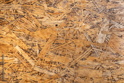Brown and yellow wooden background. Old wood, light and shadow, copy space.