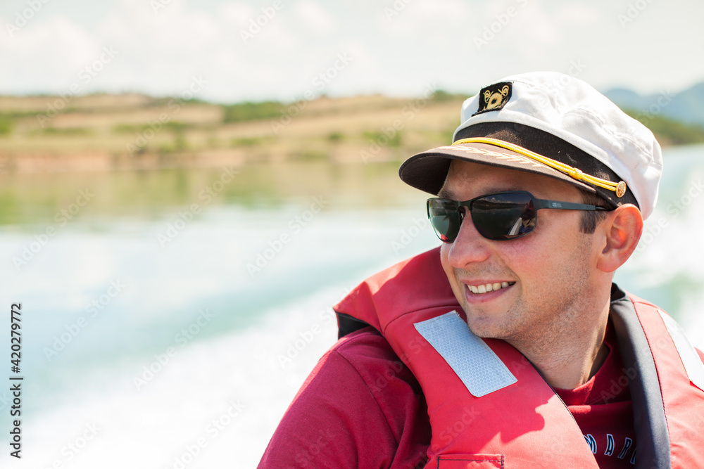 Handsome tourist enjoying adventure on boat trip Handsome tourist enjoying adventure on boat trip