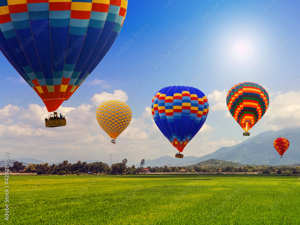 Hot air balloon team flying blue Sky landscape meadow