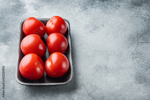 Red tomatoe, on gray background with copy space for text