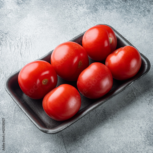 Red ripe tomatoe, on gray background