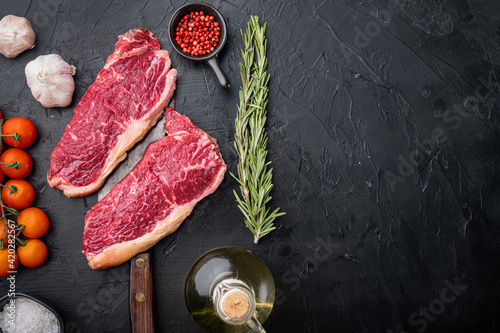New York steak, raw beef meat , on black background, top view, with copy space for text