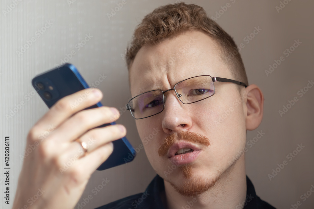 upset man speaks on a speakerphone upset man speaks on a speakerphone