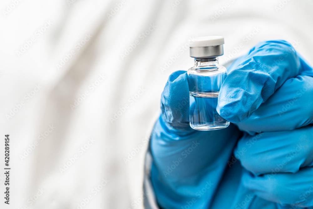 Doctor holding medicine for vaccination, closeup