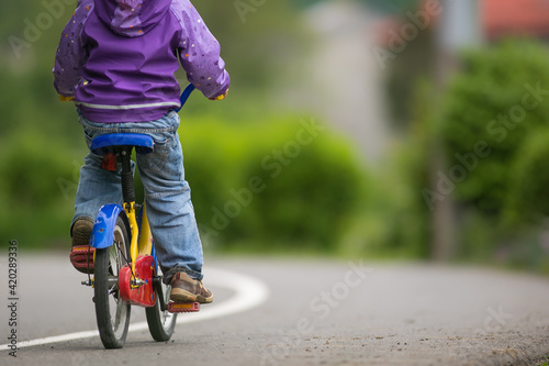 Fototapeta Naklejka Na Ścianę i Meble -  Little cyclist on a little bike (shallow DOF)