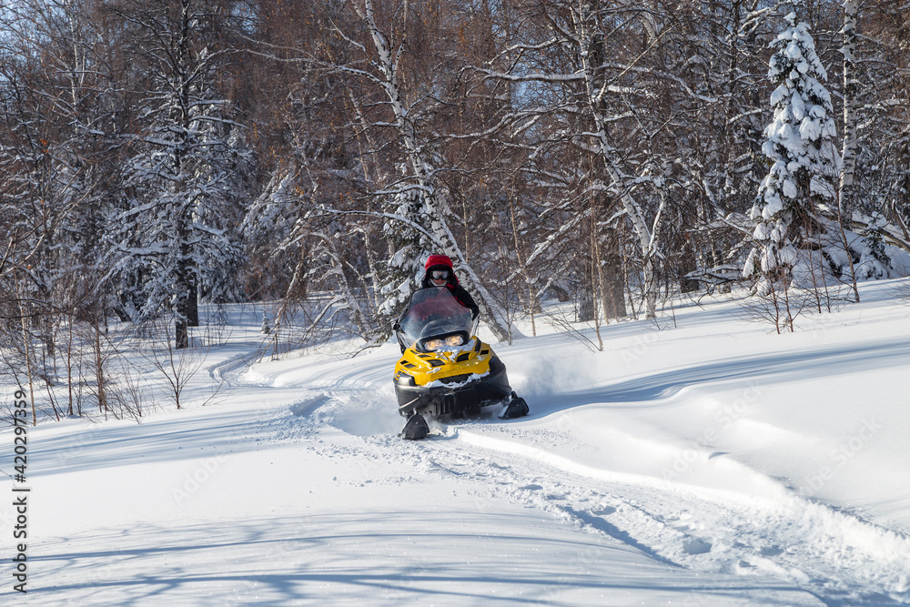 Athlete on a snowmobile.