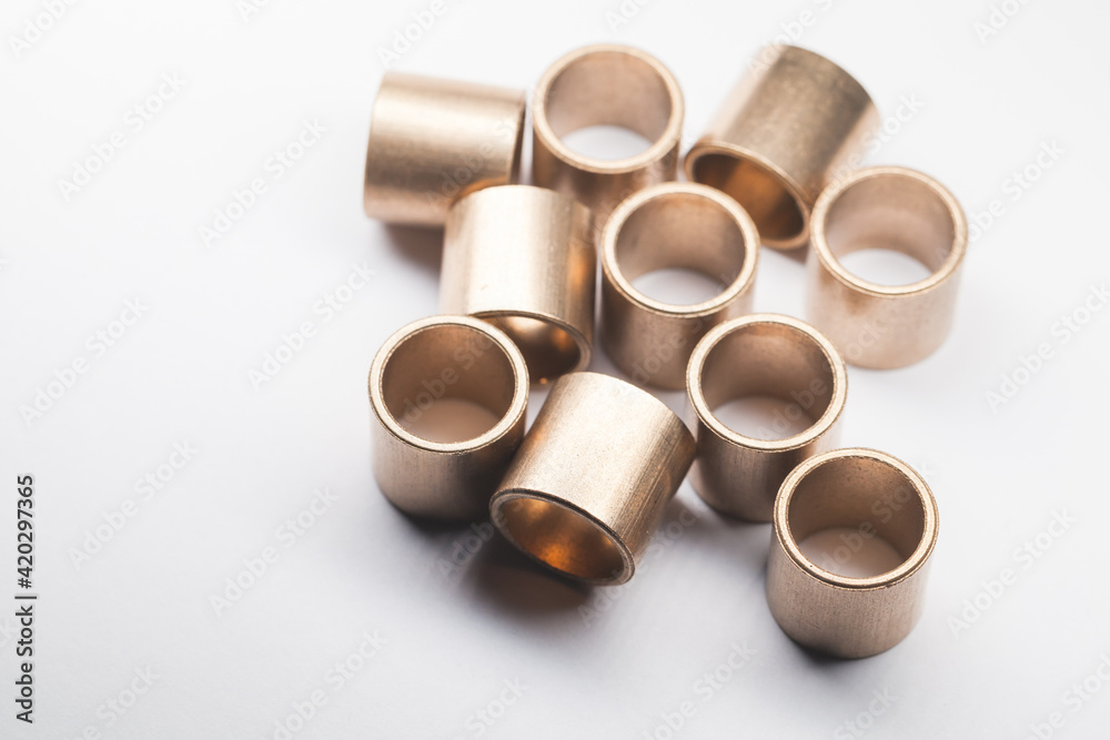 Group of sleeve bronze bearings is on a white background Group of sleeve bronze bearings is on a white background