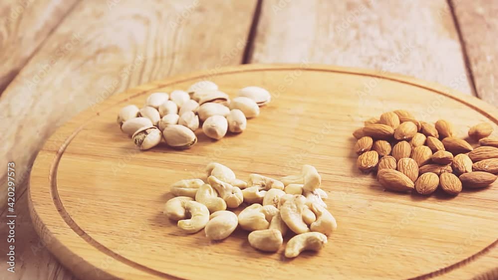 hands puts the table on a round stand with nuts and sets the kiddush wine hands puts the table on a round stand with nuts and sets the kiddush wine