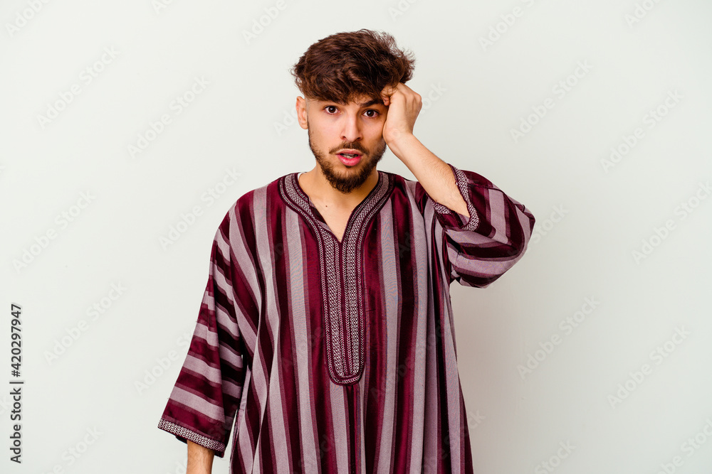 Young Moroccan man isolated on white background being shocked, she has remembered important meeting.