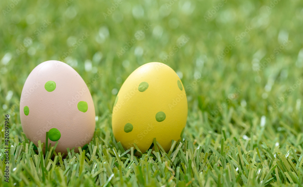 Happy Easter. Pastel colored eggs on green grass, close up view Happy Easter. Pastel colored eggs on green grass, close up view