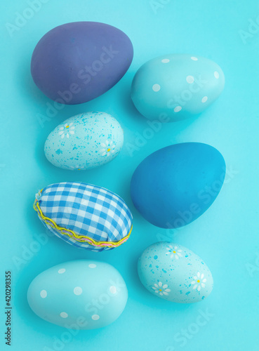 Happy Easter. Blue pastel color eggs variety on blue background